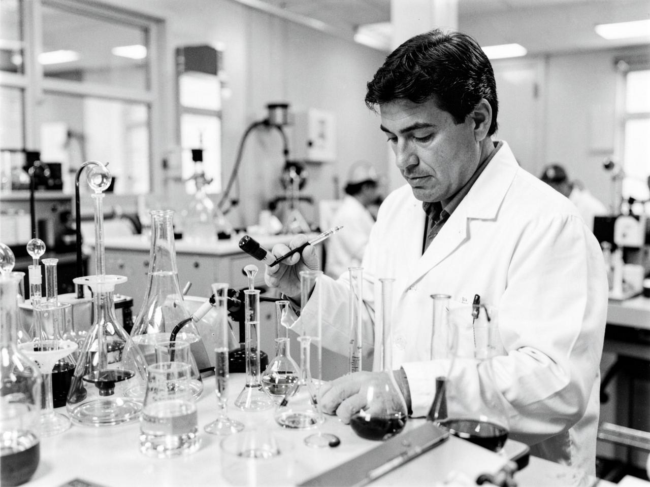 Chemist testing crude oil samples in a laboratory