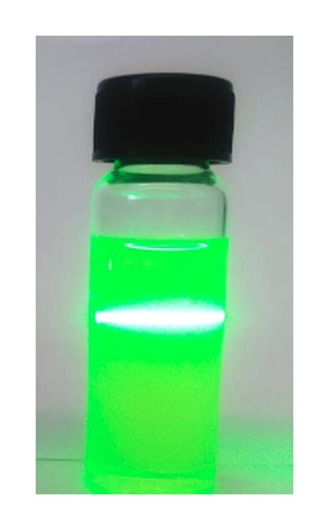 Glass vial containing the Dispersoil nanofluid with a laser beam passing through it, showing strong light scattering